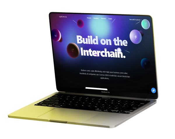 Laptop displaying 'Build on the Interchain' with colorful spheres on the screen.